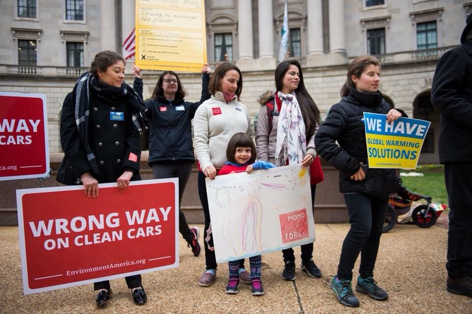 Advocates rally for clean car standards outside a government building